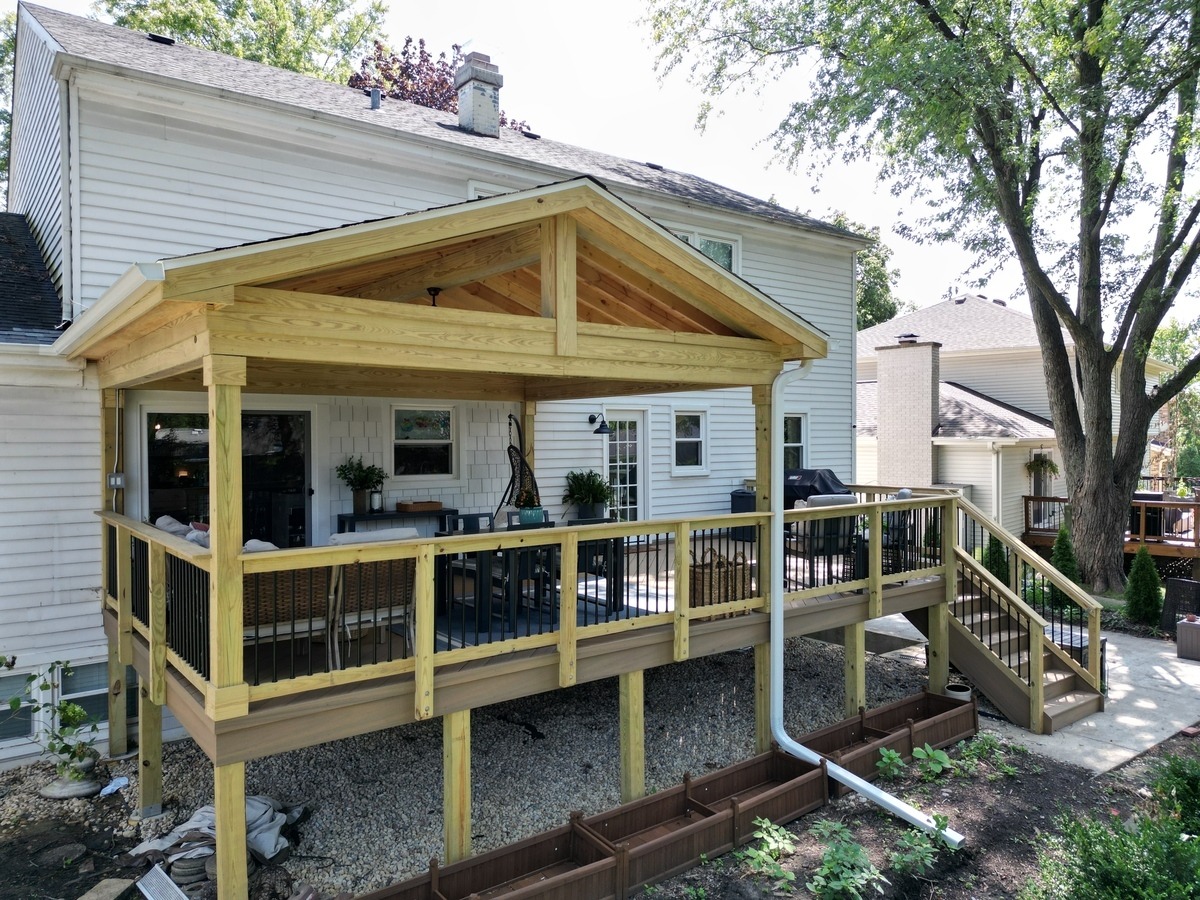wood porch on the back of a white home